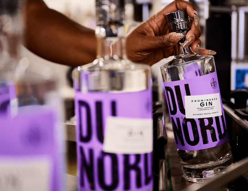 A bottle of Du Nord Prominence Gin is picked up from the bottling line.